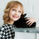 Girl Holding Black Rabbit